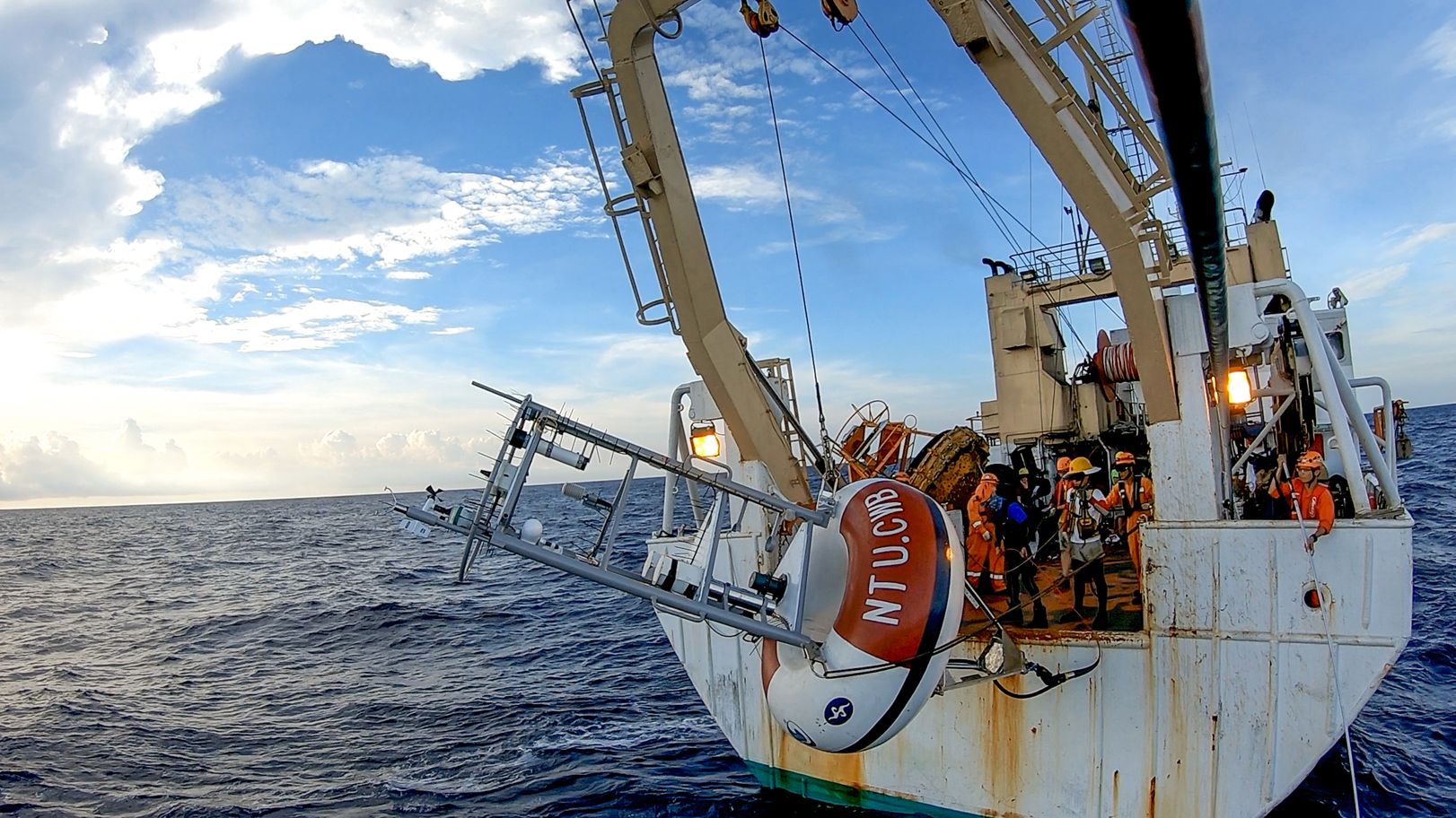 The NTU buoy and team members in 2016 (Right: Associate Professor Yiing Jang Yang)